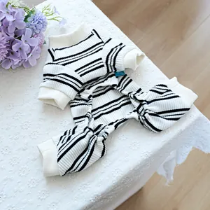 Detail of striped pet jumpsuit made of ribbed cotton fabric laid on white lace