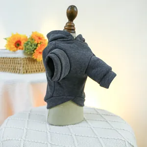 Close-up of a warm dark gray pet hoodie with ribbed cuffs on a small wooden mannequin