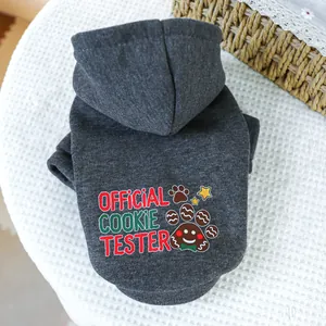 Detail of grey pet hoodie with 'Official Cookie Tester' festive print on knit background