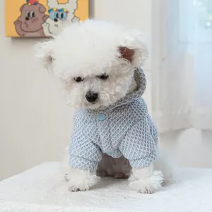 Close-up of light blue waffle texture fabric and button details on a pet winter hoodie