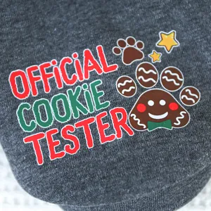 Detail of grey knitted pet hoodie with Official Cookie Tester Christmas print and gingerbread