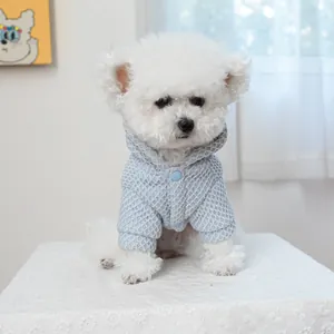 Blue waffle knit pet hoodie with buttons for small dogs shown on a white Bichon Frise