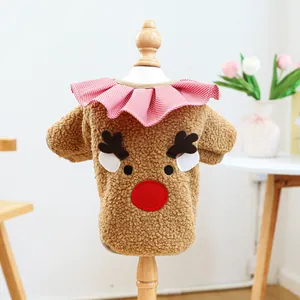 Close-up of brown fleece pet Christmas vest with elk embroidery and plaid ruffle
