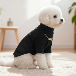 Close-up of a black knit pet turtleneck with a gold LOVE chain on a small dog