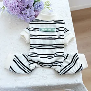 Classic black and white striped four-legged pet pajamas with a green patch on lace