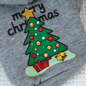Macro shot of gray knit pet hoodie featuring Christmas tree and bell print detail