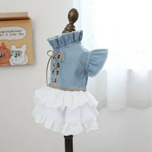 Detail of denim dog dress with white lace tiers and delicate floral embroidery