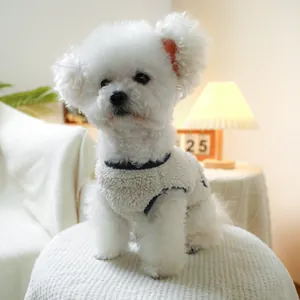 Detail of soft fleece pet vest on small dog in a cozy home setting with warm lighting