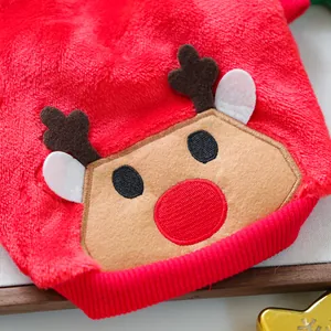 Close-up of red plush pet sweater featuring reindeer embroidery and soft velvet texture