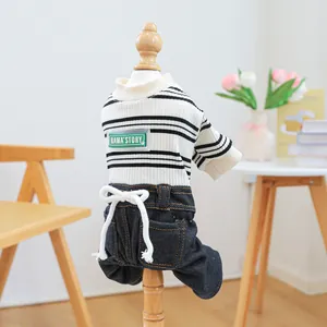 Detail of striped pet jumpsuit with denim pants on a wooden display stand
