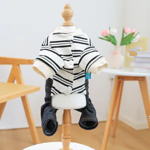 Close-up of striped dog jumpsuit with denim pants on a pet mannequin in home setting