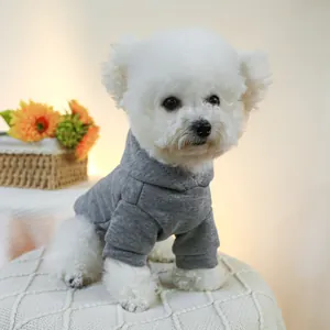 Close-up of a soft dark gray pet hoodie with a cozy hood worn by a white Bichon dog