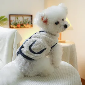 Detail of warm white sherpa pet vest with navy trim and cozy pocket for dogs