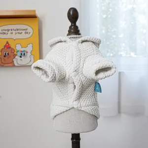 Detail of white waffle fabric pet sweatshirt with buttons and branded blue side label