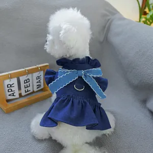 Detail of a denim pet dress featuring tiered ruffles and a D-ring for leash attachment