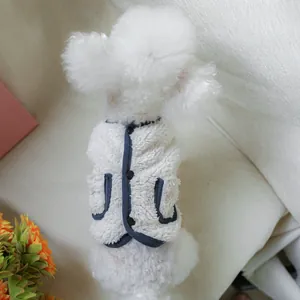 Detail of warm sherpa pet vest featuring navy trim and front button closure