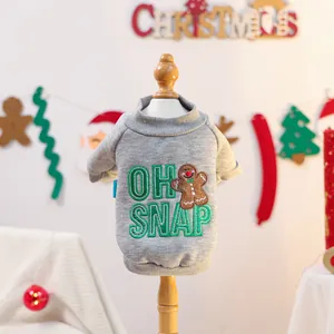 Detail of grey pet Christmas sweater with green Oh Snap embroidery and gingerbread man pattern