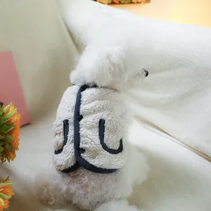 Warm white fleece pet vest with navy trim and decorative pockets for small dogs