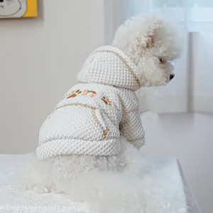 Detail of white waffle knit pet hoodie showing hood design and small back pocket