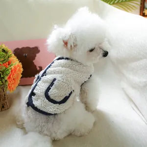 Detail of warm lamb wool pet vest with navy blue trim and a side decorative pocket