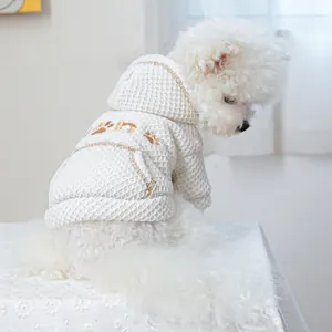 Close-up of white pet hoodie with waffle texture, gold sequin embroidery and kangaroo pocket