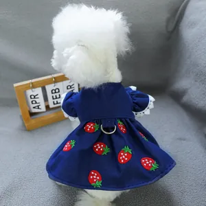 Close-up of strawberry embroidery and metal D-ring on a denim pet dress for small dogs