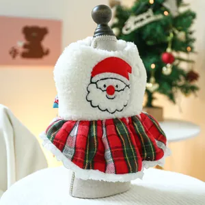 Detail of Christmas pet vest with Santa embroidery and festive red plaid skirt