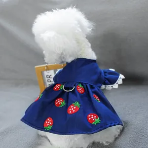 Detail of dark blue pet dress with strawberry embroidery, lace trim, and D-ring