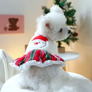 Detail of Christmas pet outfit featuring Santa Claus embroidery and red plaid skirt
