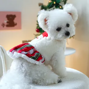 Close-up of pet Christmas vest with white fleece and red green plaid ruffle detail