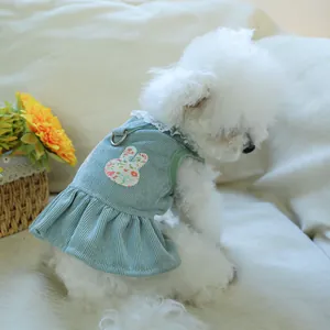 Detail of pet dress featuring mint green corduroy fabric with lace trim and floral bunny patch