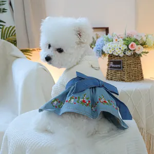 Detail of dog denim dress with floral embroidery and white hollow knit bodice