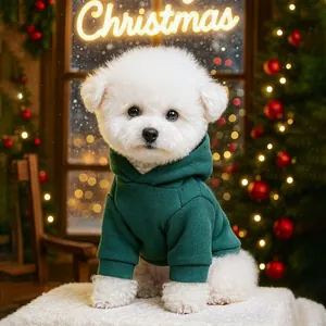 Detail of dark green pet hoodie on small white dog with festive Christmas background