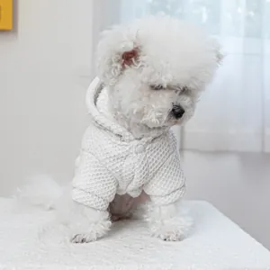 Detailed waffle-knit texture of a white hooded pet sweater on a small dog model