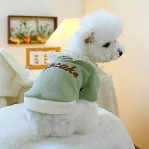 Detail of light green dog sweatshirt with cupcake embroidery and white ruffle collar