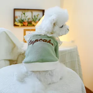 Detail of light green pet sweatshirt with cupcake embroidery and white ruffled collar