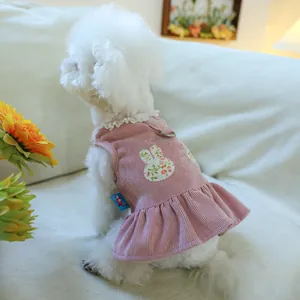 Pink corduroy dog dress featuring floral bunny patch and lace collar with metal D-ring