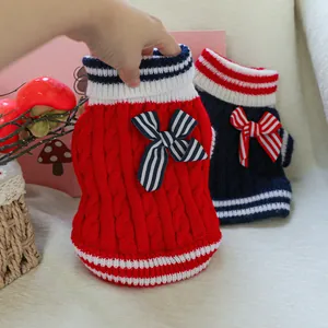 Detail of nautical style pet sweaters with knit cable texture and striped bows