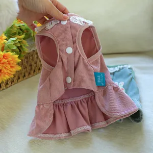 Detail of pink striped corduroy pet dress with white lace collar and snap buttons