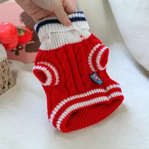 Macro detail of red cable-knit pet sweater with striped navy collar for small dogs