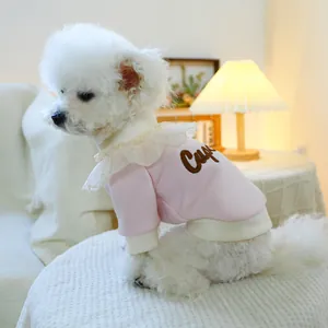 Close-up of pink pet sweatshirt with white lace collar and Cupid embroidery on a dog