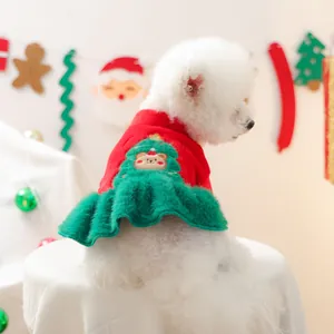 Detailed view of a Christmas pet dress with reindeer embroidery and plush green skirt trim