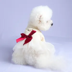 Detail of pet princess dress with red bow and D-ring on white knit and mesh tutu