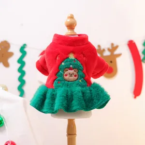 Detail of red and green plush pet Christmas dress with festive bear embroidery