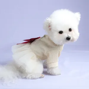 Detail of pet dress with cream knit fabric and large burgundy satin bow on mesh skirt