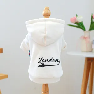 Detail of cream pet hoodie featuring black London print on soft cotton fabric