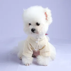 Detail of pet knit cardigan with beige rib texture and white mesh skirt on a Bichon