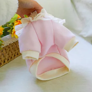 Detail of pink pet sweatshirt showing lace collar and soft fleece fabric texture