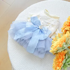 Close-up of pet dress with lace top, silver snowflake patch, and blue mesh tutu skirt