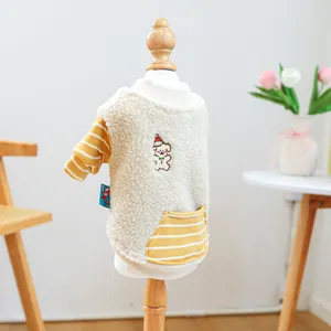 Detail der gelb gestreiften Ärmel und des Sherpa-Fleece auf einem Haustierpullover mit Stickerei